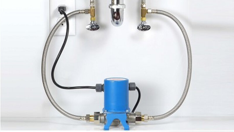 Hot water recirculation pump installed under bathroom sink for instant hot water - Warren Brothers Plumbing serves Bastrop, Austin, and Elgin TX